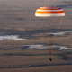 The Soyuz TMA-20M spacecraft capsule carrying International Space Station (ISS) crew descends beneath a parachute near the town of Zhezkazgan (Dzhezkazgan), Kazakhstan